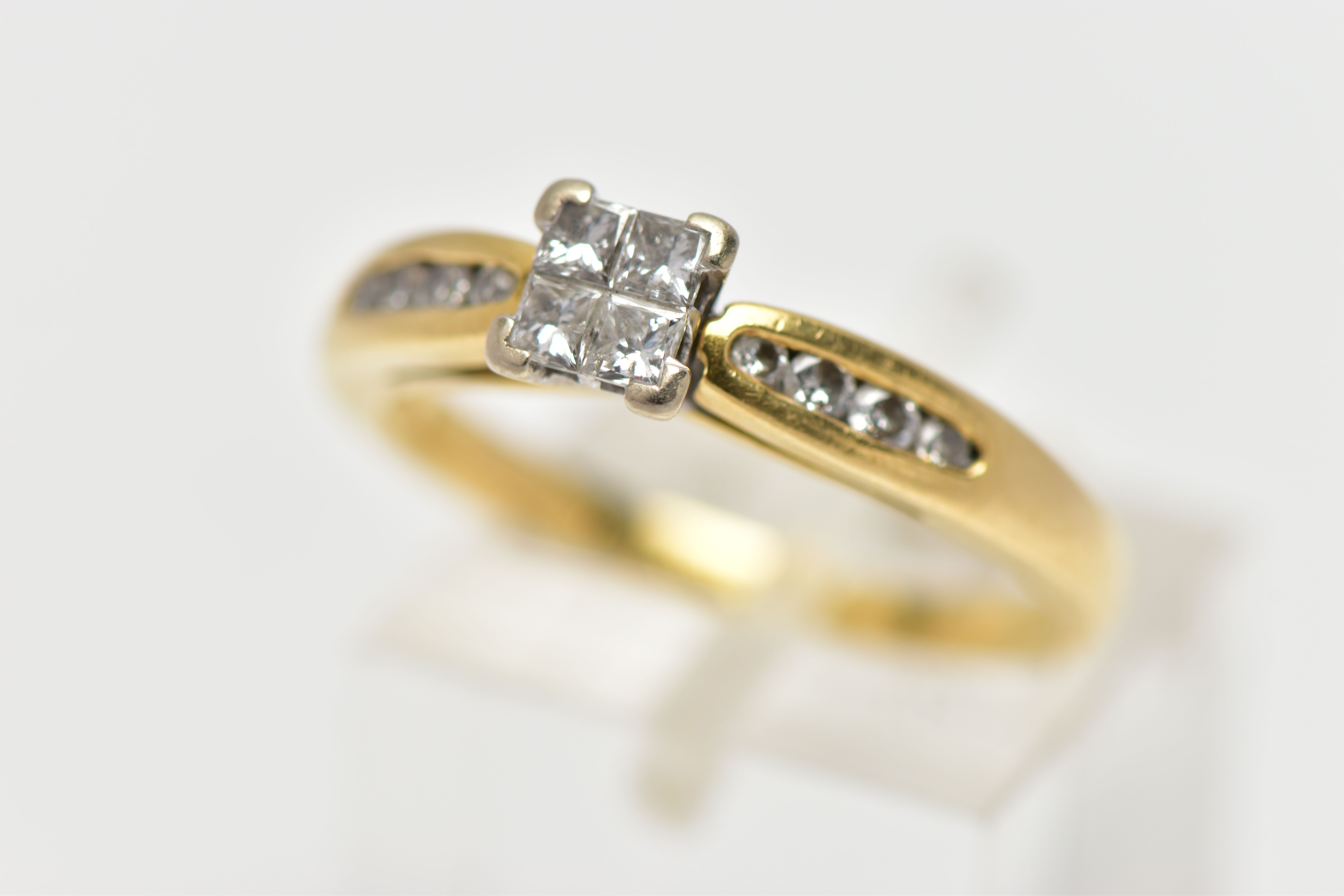 AN 18CT YELLOW GOLD DIAMOND RING, set with a square shape panel of four princess cut diamonds, to