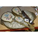 A PETIT POINT LACE VANITY SET, comprising a gilt edged tray, matching mirror, brush and comb (4) (