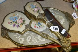 A PETIT POINT LACE VANITY SET, comprising a gilt edged tray, matching mirror, brush and comb (4) (
