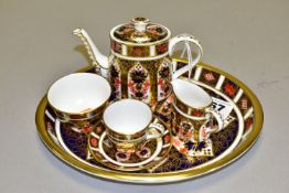 A ROYAL CROWN DERBY IMARI 1128 MINIATURE TEA SET, comprising an oval tray, teapot, cream jug,