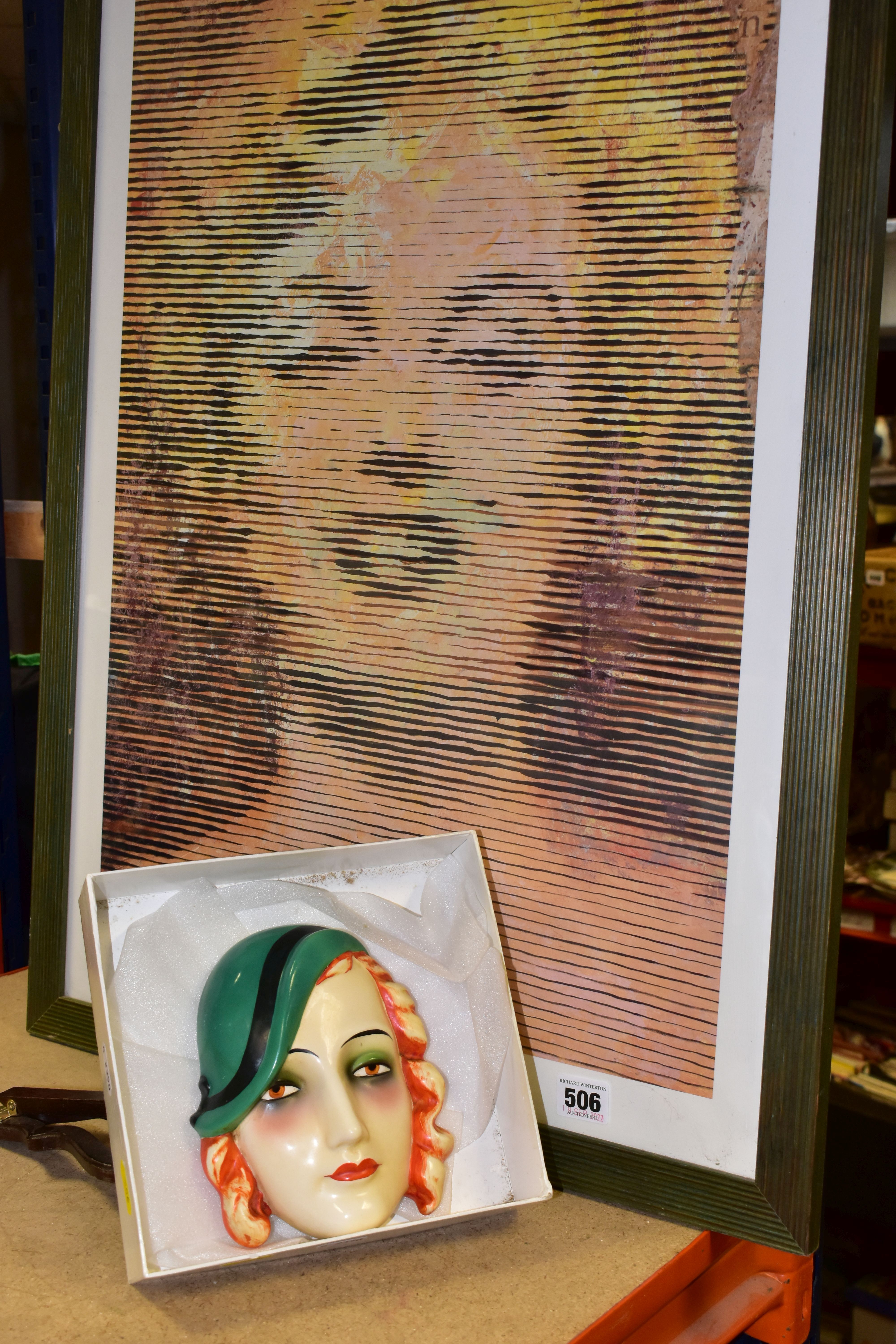 AN ART DECO GOEBEL FACE MASK, of a red haired lady wearing a green hat, impressed backstamp verso,