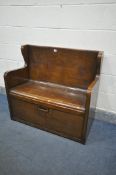 AN OAK HALL SETTLE, with fall front storage compartment, length 97cm x depth 48cm x height 88cm (