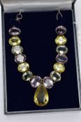 A SILVER VARI QUARTZ NECKLACE, the necklace comprising variously cut quartz collets, the largest