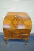 AN ART DECO WALNUT BUREAU, with a book matched veneer fall front, enclosing a fitted interior, two