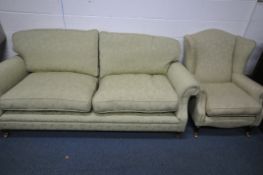 A GREEN UPHOLSTERED TWO PIECE LOUNGE SUITE, comprising a three seater settee, length 212cm, and a