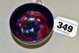 A MOORCROFT POTTERY MINIATURE BOWL, decorated in Pansy pattern on a dark cobalt blue ground,