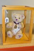 A COMMEMORATIVE STIEFF TEDDY BEAR IN A WOODEN FRAMED PROTECTIVE CASE, a small blonde bear, with a