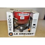 A BOXED AND UNUSED LE CREUSET CHERRY RED FONDUE SET, containing six stainless steel fondue forks (