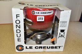 A BOXED AND UNUSED LE CREUSET CHERRY RED FONDUE SET, containing six stainless steel fondue forks (