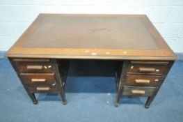 A 20TH CENTURY OAK PEDESTAL DESK, with brown writing surface, an arrangement of six drawers, and two