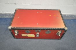 A RED LEATHERETTE RECTANGULAR TRAVELING TRUNK, with black plastic and studded banding, width 90cm