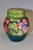 A MOORCROFT POTTERY HIBISCUS PATTERN COVERED GINGER JAR, the green ground decorated with pink,