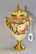 A COALPORT COVERED VASE, with twin gilt ram's head handles, gilt base, rim and finial, painted