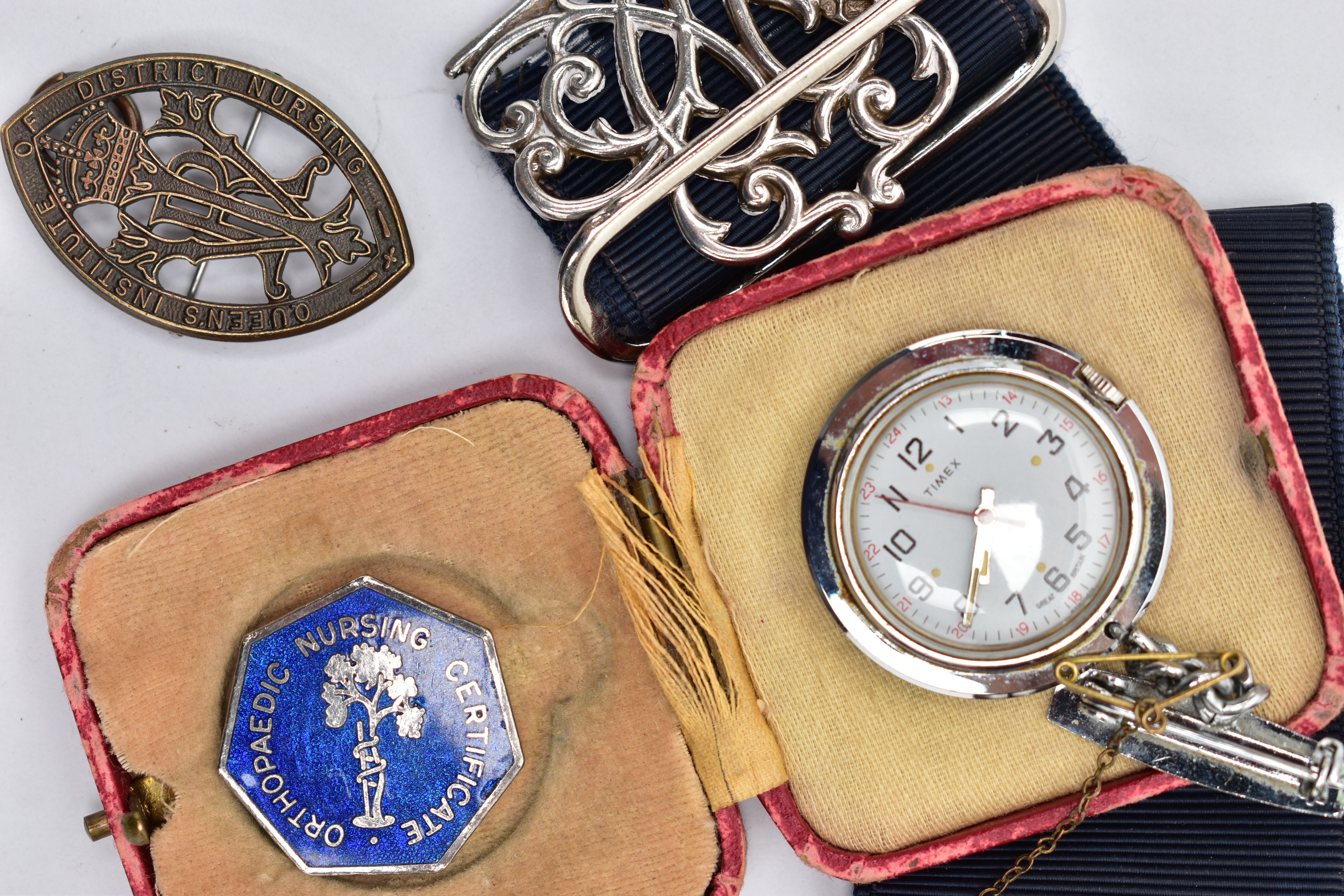 A SILVER NURSES BELT BUCKLE AND NURSING BADGES, a silver open work belt buckle fitted to a stretch - Image 2 of 3