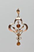 A YELLOW METAL PASTE SET PENDANT, the openwork foliate pendant, with circular cut central orange