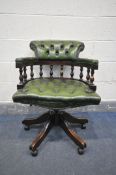 A GREEN BUTTONED LEATHER SWIVEL OFFICE CHAIR (condition:-no armrests filling, so hard to touch)