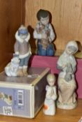 FOUR LLADRO AND NAO FIGURINES, comprising a boxed Lladro Eskimo Boy with Pet 5238 designed by Juan