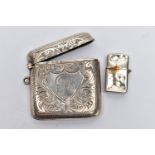 A SILVER VESTA AND WHITE METAL LIGHTER, foliage engraving and monogram engrave cartouche, hinged