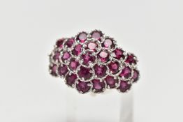 A SILVER TOURMALINE COCKTAIL RING, designed as a cluster of raised circular cut pink tourmalines,