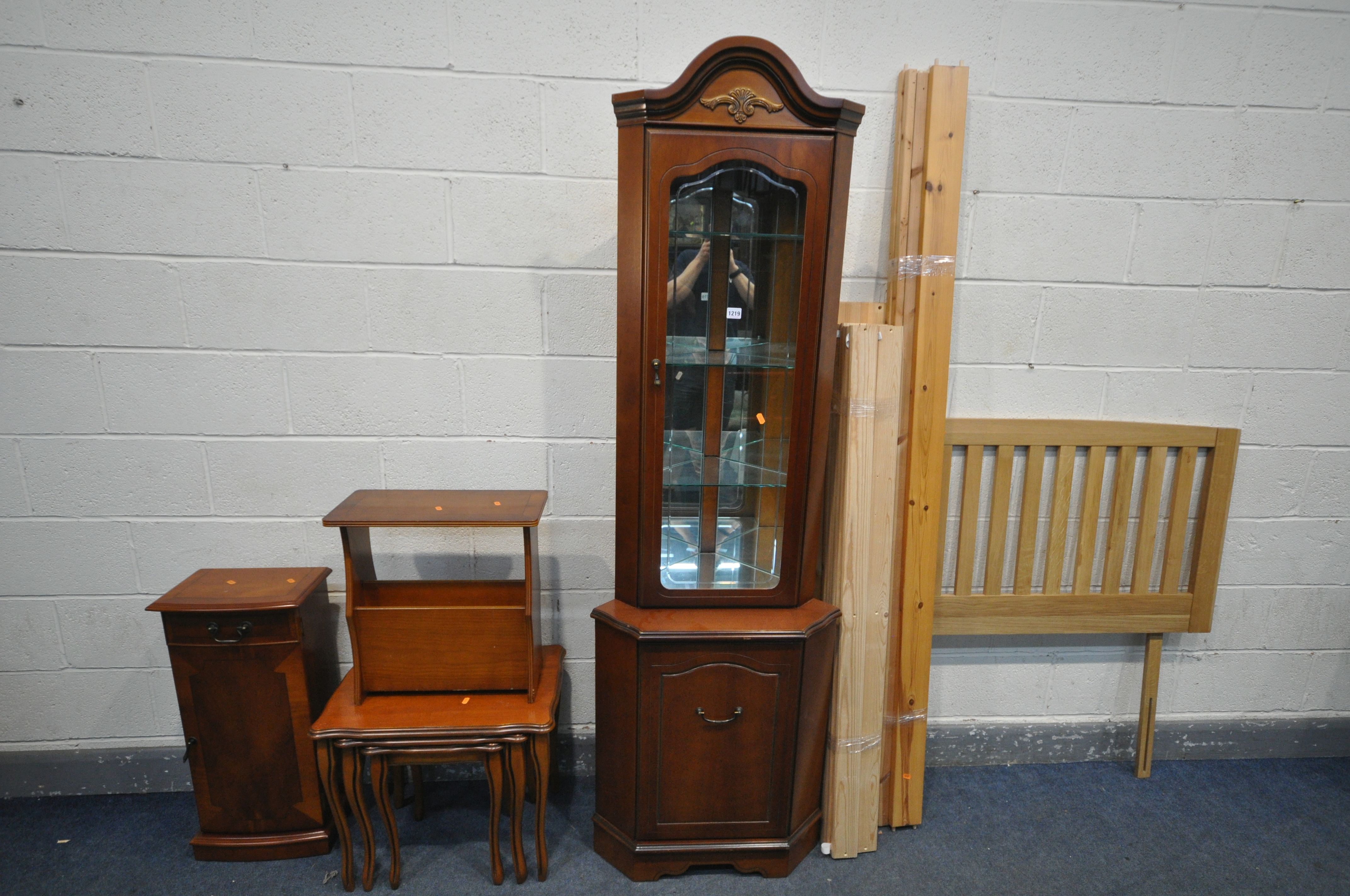 A CHERRYWOOD GLAZED CORNER CUPBOARD, a nest of three tables, yew wood magazine rack, a small