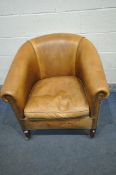 A TANNED LEATHER TUB CHAIR, on front square tapering legs, with brass casters, width 87cm x depth