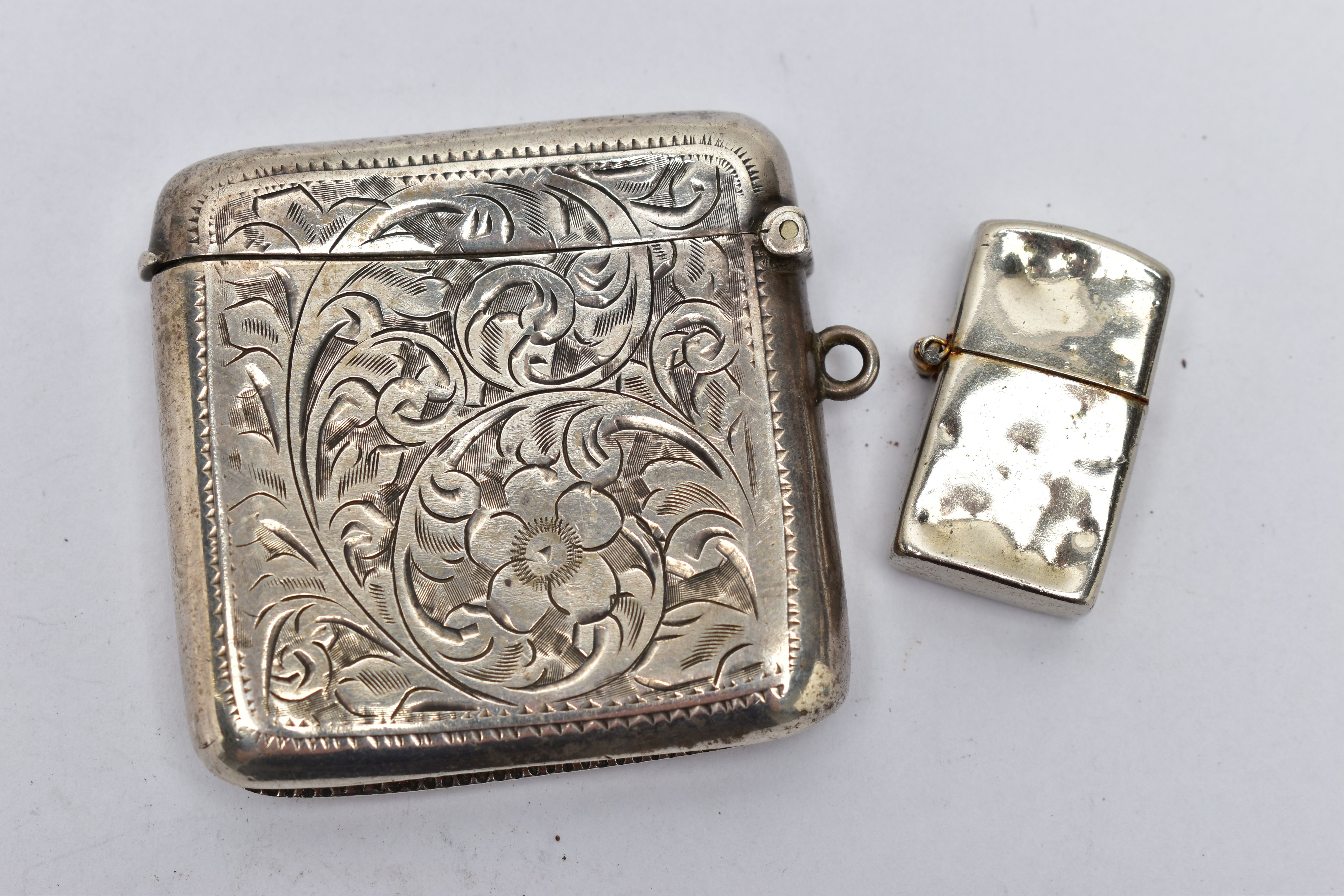 A SILVER VESTA AND WHITE METAL LIGHTER, foliage engraving and monogram engrave cartouche, hinged - Image 2 of 2