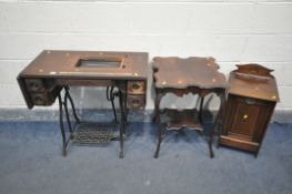 A VINTAGE TREADLE SEWING MACHINE (condition:-missing lid and machine, veneer loss) an Edwardian