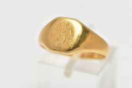 AN EARLY 20TH CENTURY 18CT GOLD SIGNET RING, the cushion shape panel with faded monogram detail,