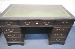 A MAHOGANY PEDESTAL DESK, with a green leather writing surface, and an arrangement of drawers,