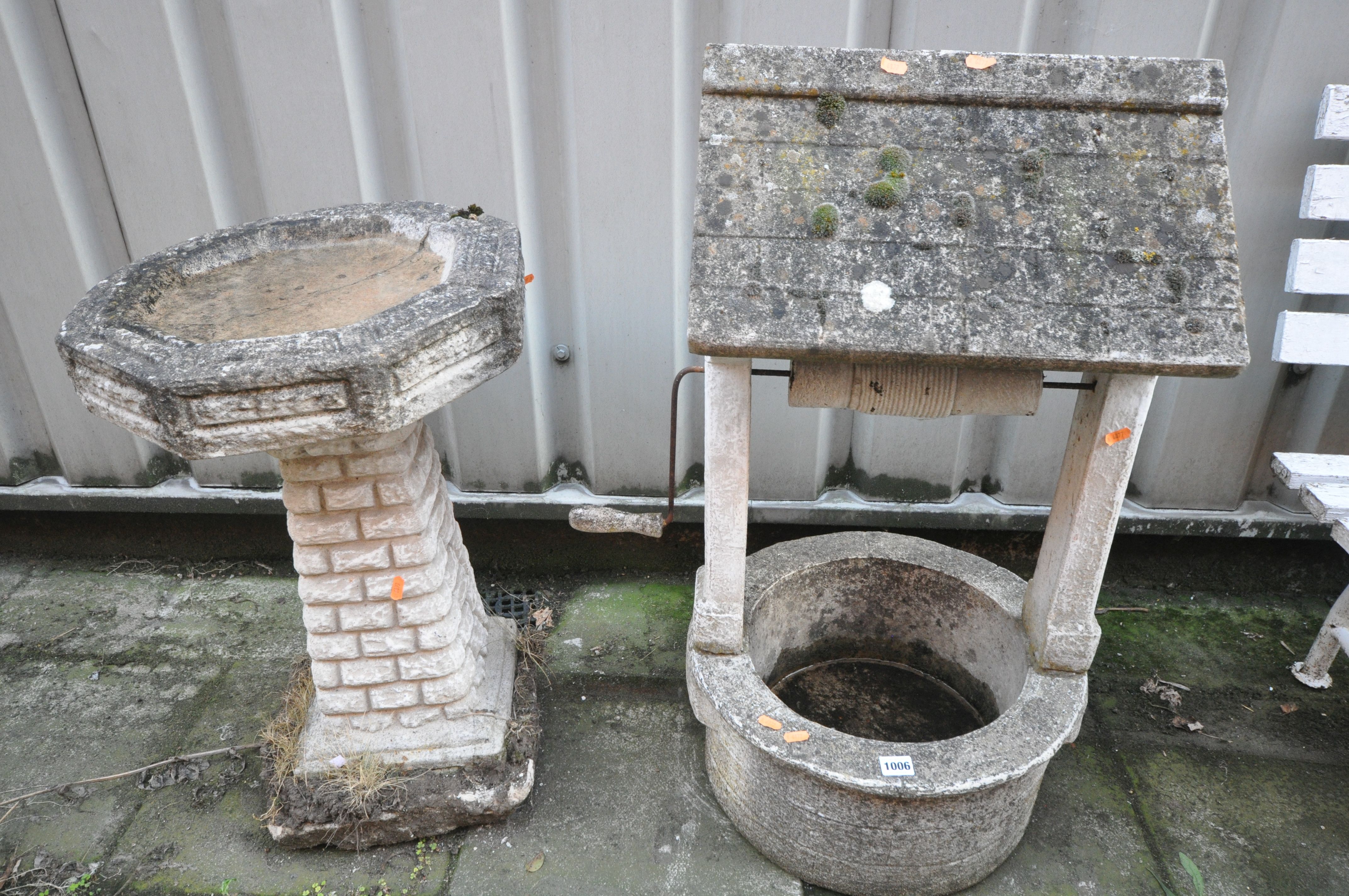 A WEATHERED COMPOSITE WISHING WELL PLANTER, and an octagonal bird bath on a separate brick effect