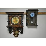 AN EARLY 20TH CENTURY GERMAN WALL CLOCK, with half turned pillar flanking a circular panel glazed