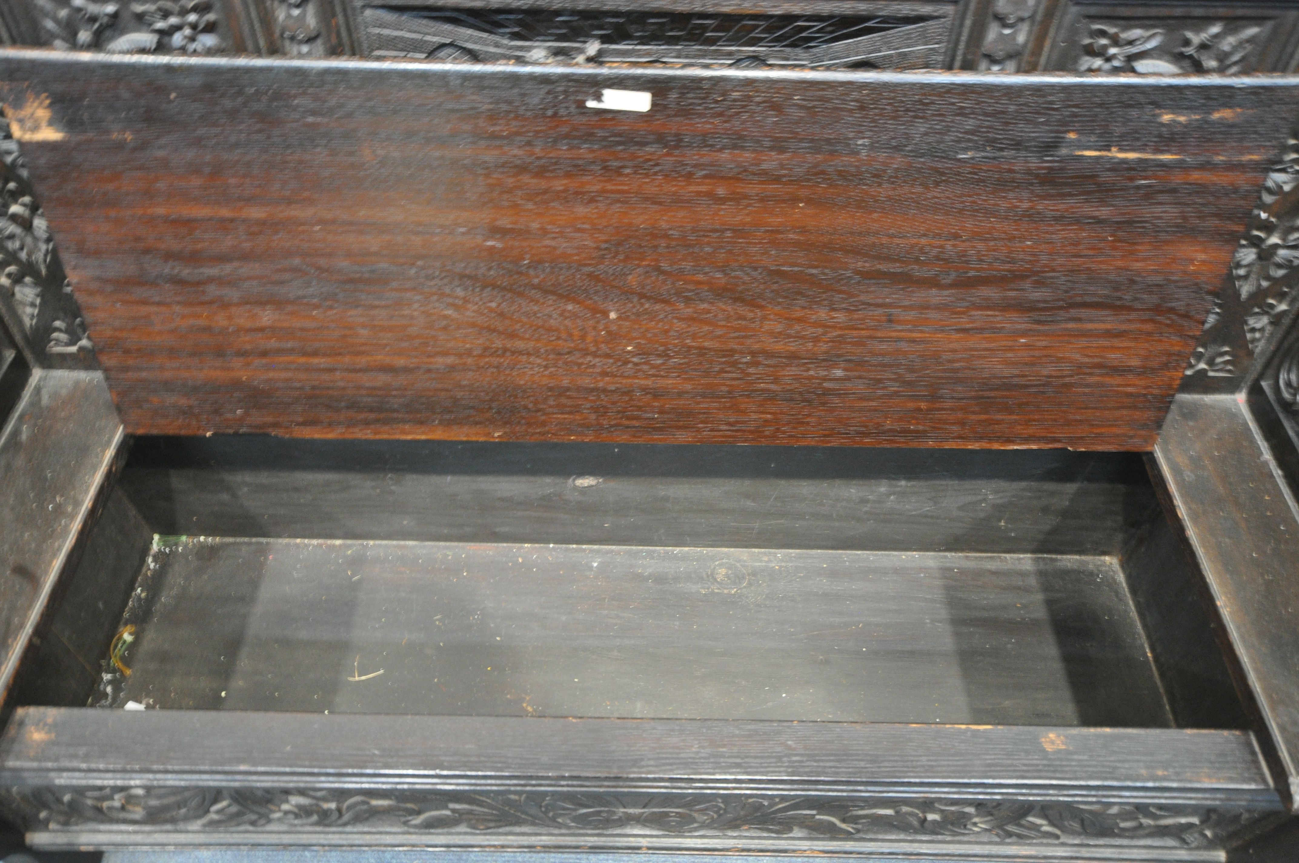 A LATE 19TH CENTURY CARVED OAK JACOBETHAN STYLE HALL SETTLE/BENCH, the two outer panels depicting - Image 7 of 9