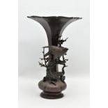 A LATE 19TH CENTURY JAPANESE MEIJI PERIOD BRONZE VASE, the trumpet shaped rim over a slender