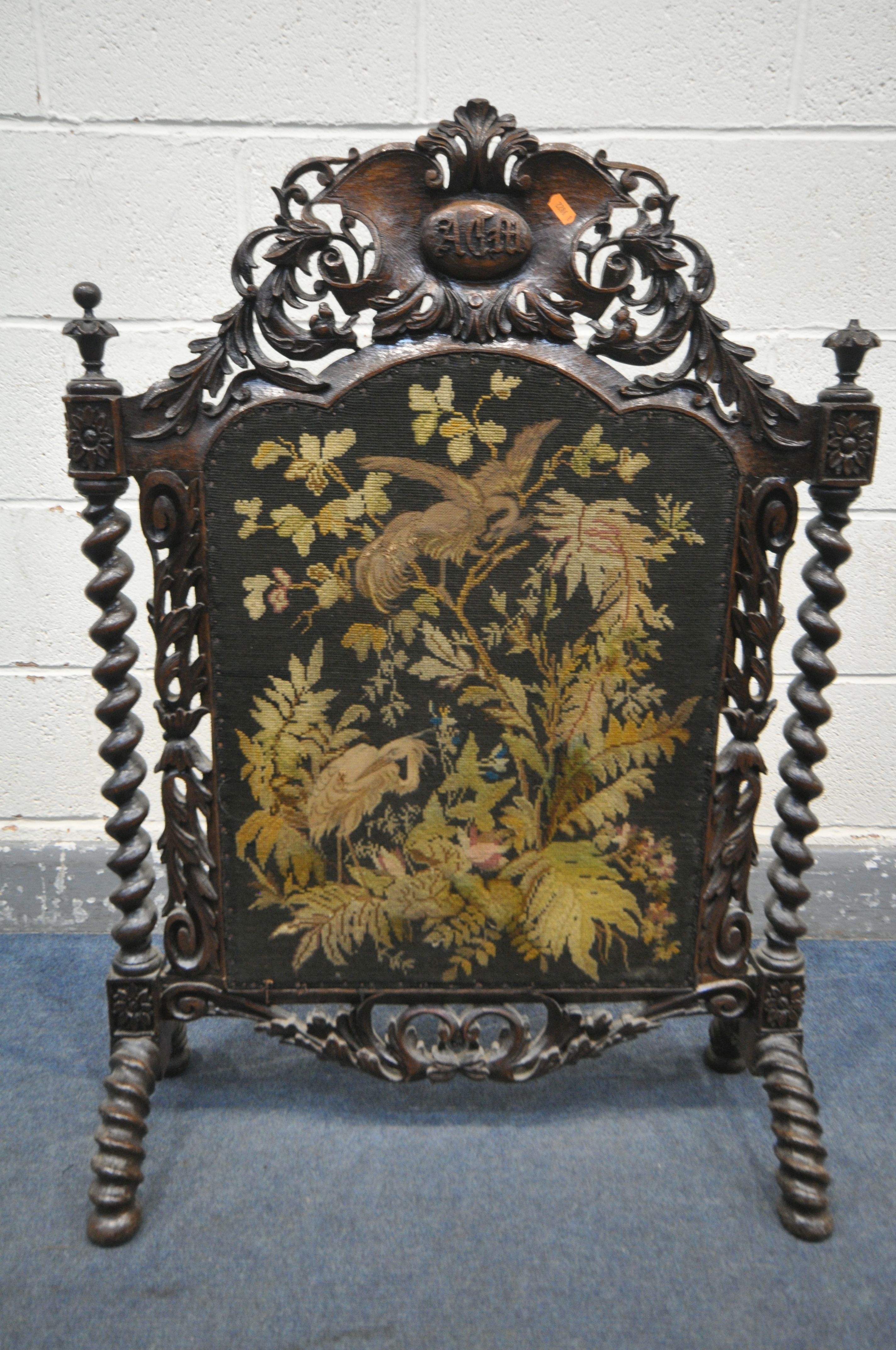 A VICTORIAN CARVED OAK FIRESCREEN, the detailed foliate decorated frame, central lettering reading - Image 2 of 6