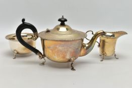 A GEORGE V SILVER THREE PIECE TEA SET OF CIRCULAR FORM, cast bobbin rims, tea pot with ebonised