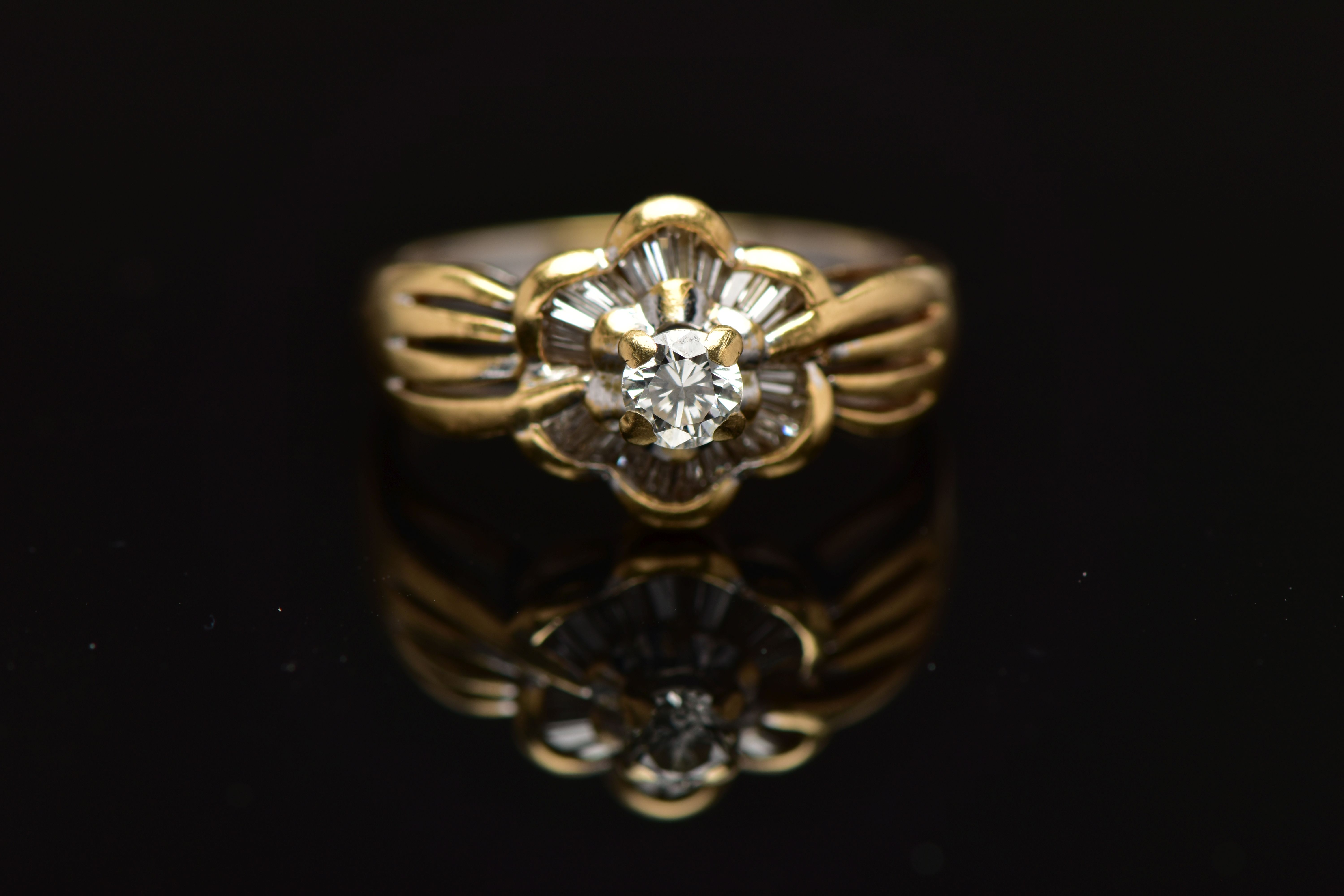 A MODERN YELLOW METAL DIAMOND CLUSTER RING, set with a principal round brilliant cut diamond, within - Image 8 of 8