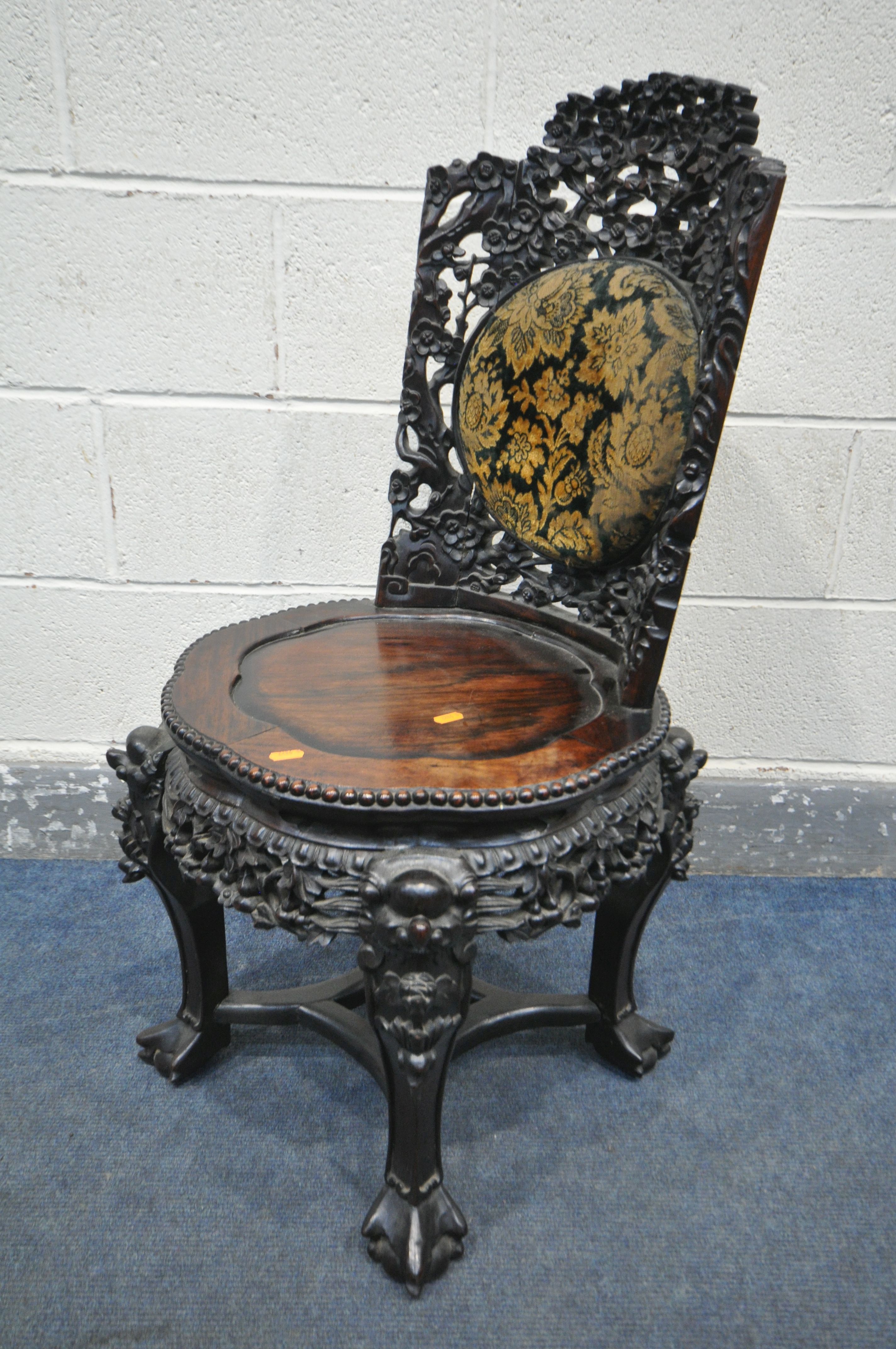 AN INTRICATLY CARVED CHINESE HARDWOODCHAIR, late 19th/early 20th century, flower heads and vines