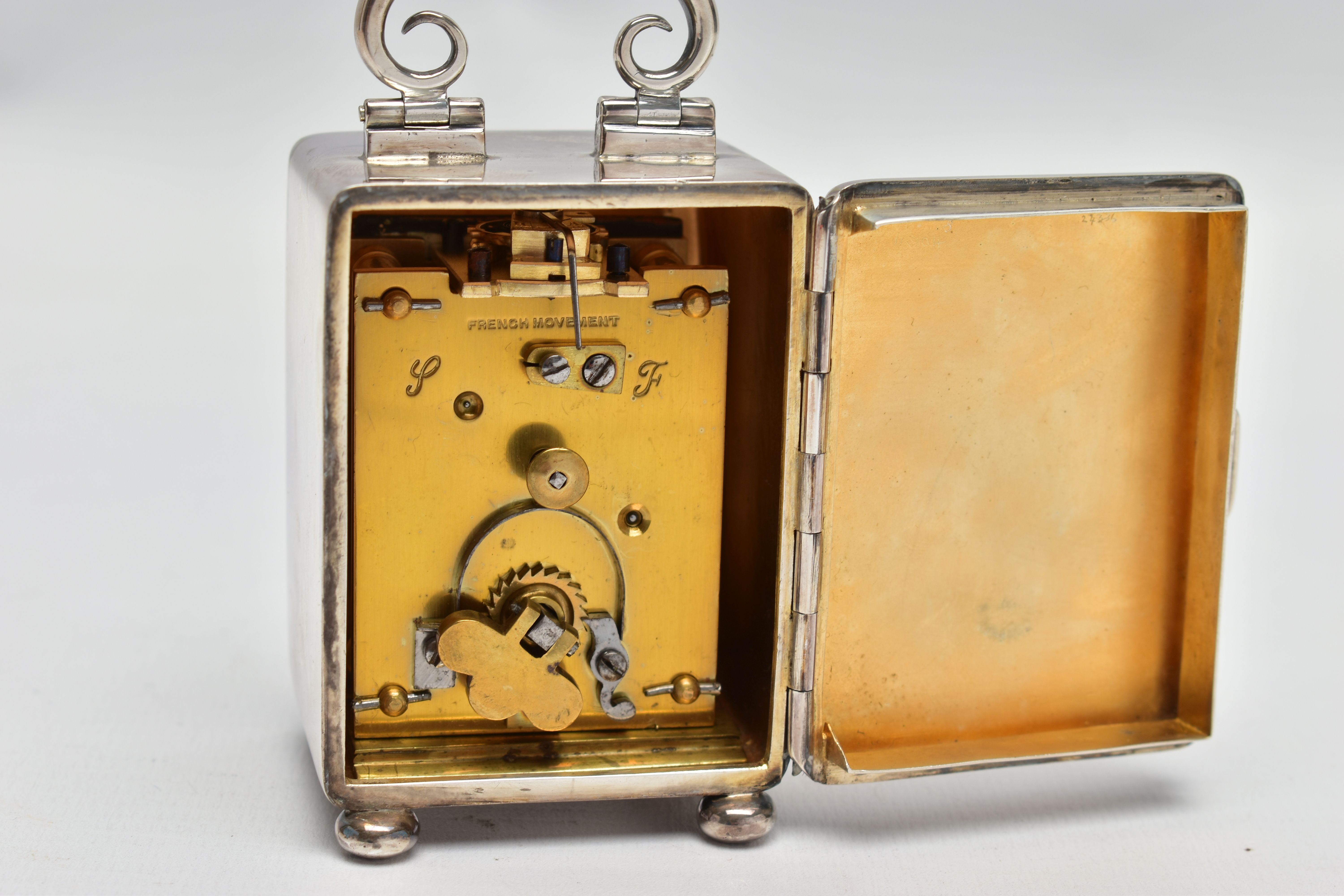 AN EDWARDIAN WILLIAM COMYNS MINIATURE SILVER BOUDOIR CLOCK, the plain case with swing carrying - Image 6 of 7