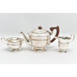A GEORGE V SILVER THREE PIECE TEA SERVICE OF CIRCULAR PANELLED FORM, reeded rims, S scroll