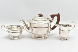 A GEORGE V SILVER THREE PIECE TEA SERVICE OF CIRCULAR PANELLED FORM, reeded rims, S scroll