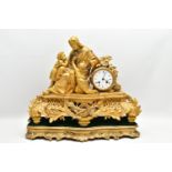 A MID 19TH CENTURY GILT METAL MANTEL CLOCK, cast with a seated figure of Christ and two children,