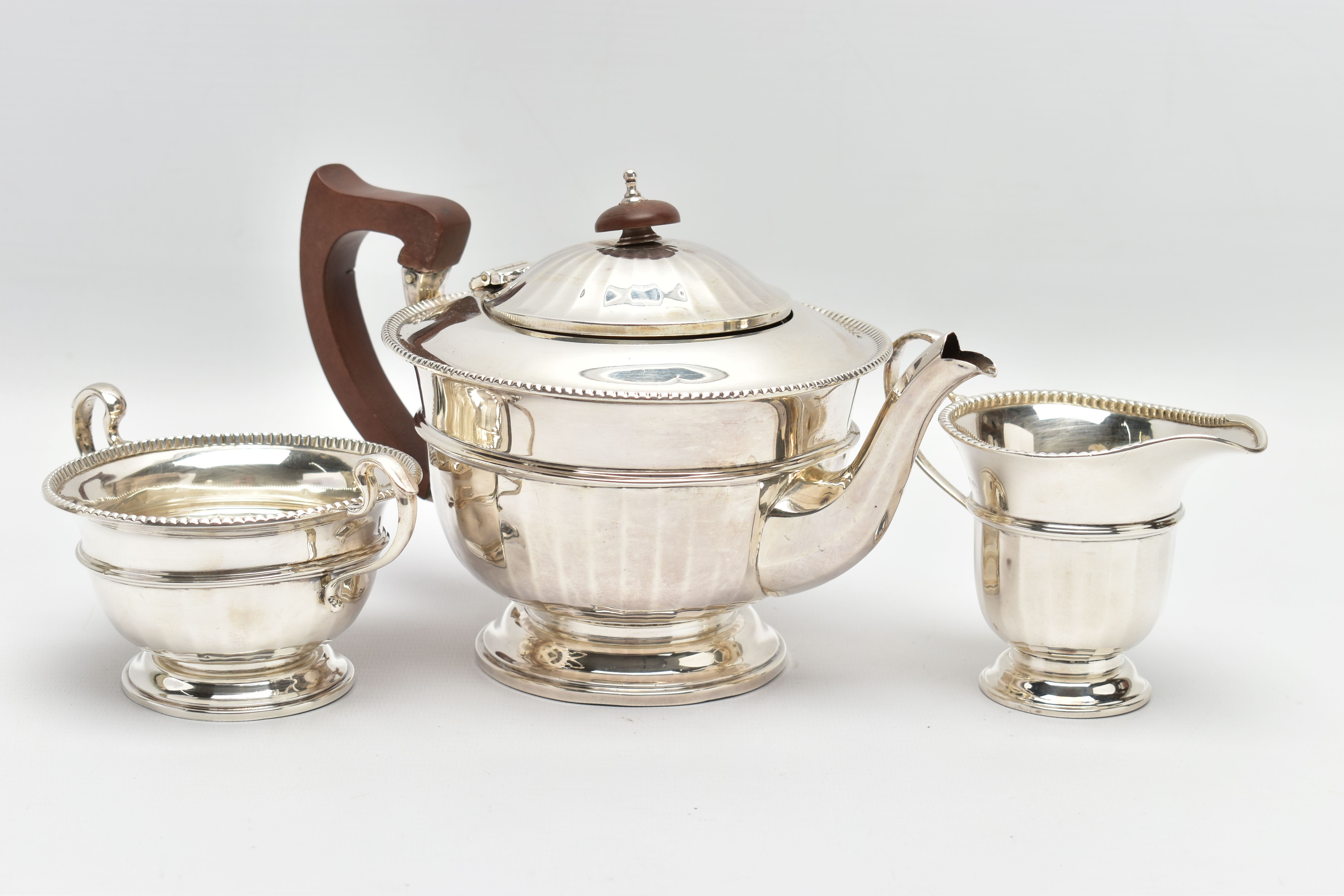 A GEORGE V SILVER THREE PIECE TEA SERVICE OF CIRCULAR PANELLED FORM, reeded rims, S scroll - Image 3 of 9