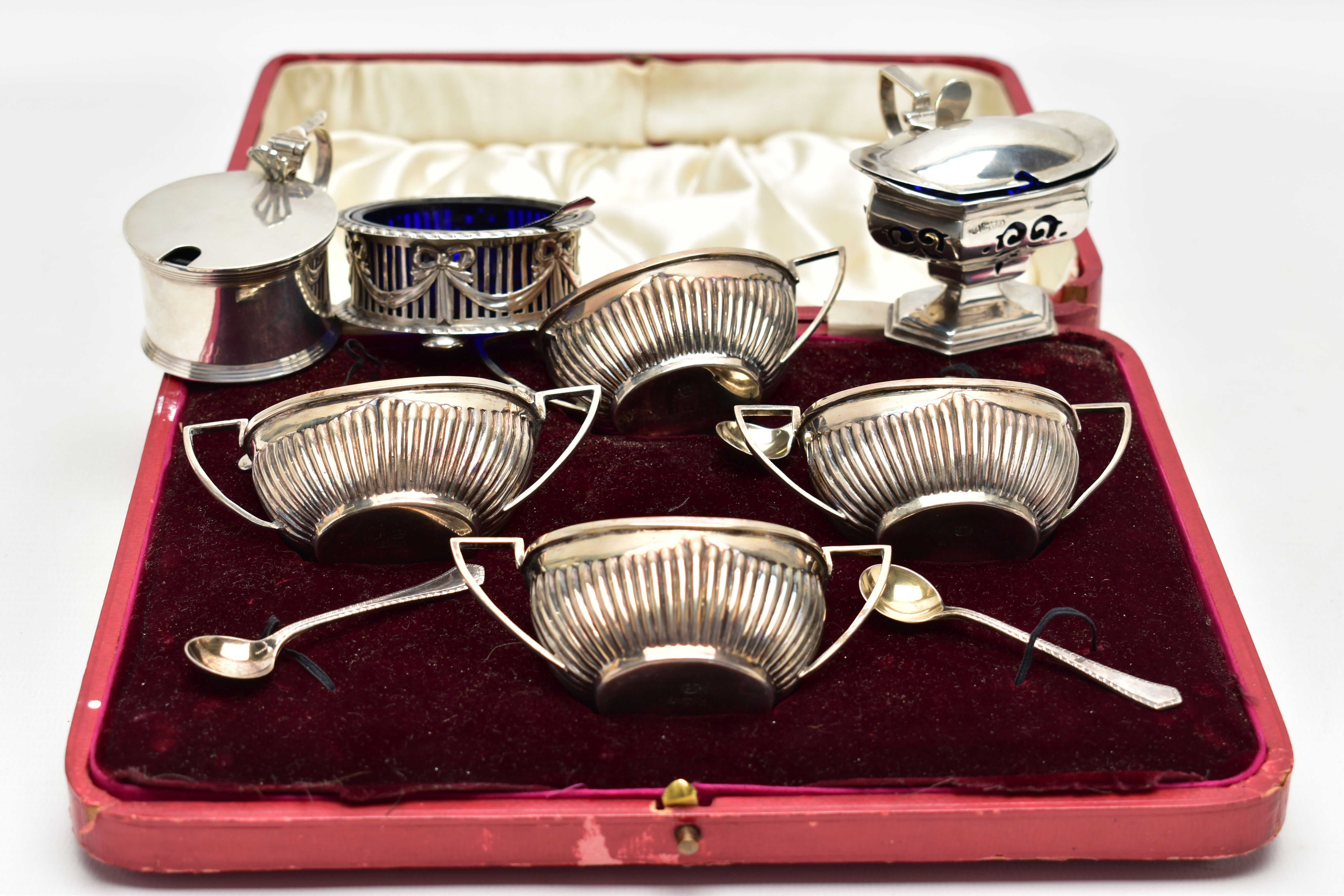 A CASED SILVER EIGHT PIECE CRUET SET, TOGETHER WITH THREE OTHER CONDIMENT ITEMS AND A CONDIMENT