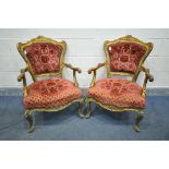 A PAIR OF 19TH CENTURY OR EARLIER LOUIS XV GILT FRAMED OPEN ARMCHAIRS, covered with later