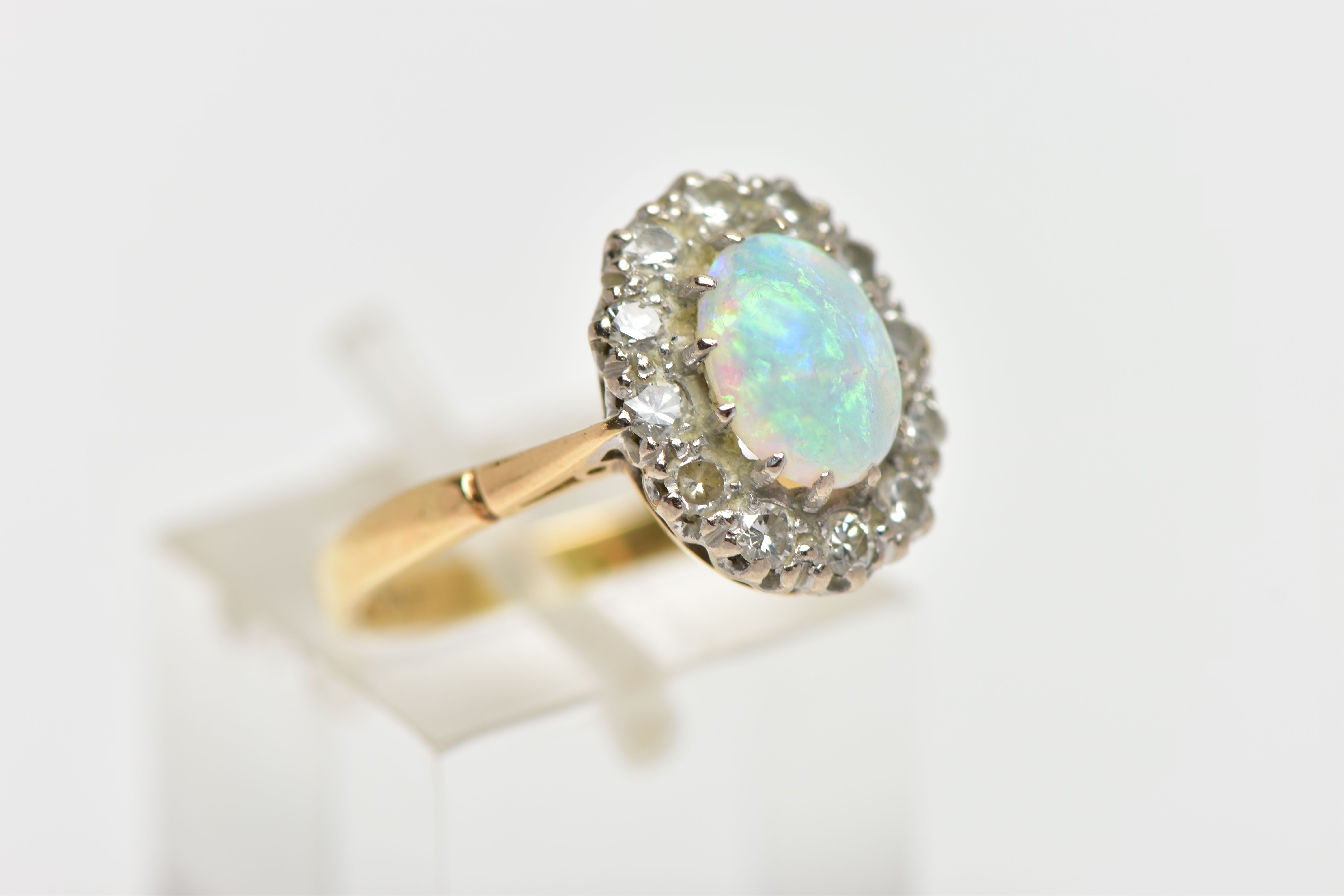 AN OPAL AND DIAMOND CLUSTER RING, set with an oval opal cabochon, measuring approximately 8.2mm x - Image 4 of 10