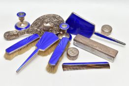 A GEORGE V BLUE ENAMEL AND SILVER SEVEN PIECE DRESSING TABLE SET, comprising a hand mirror, a hair