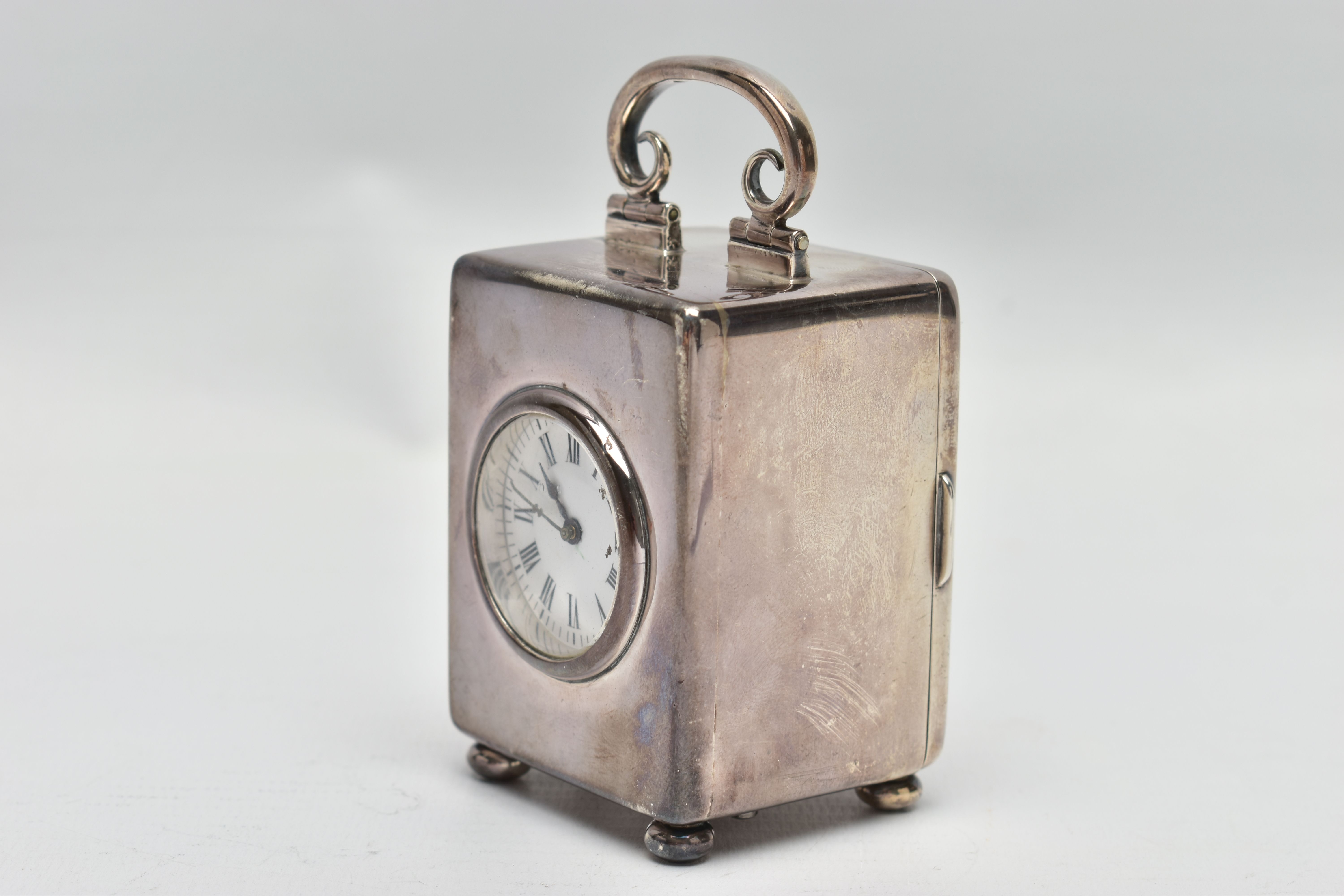 AN EDWARDIAN WILLIAM COMYNS MINIATURE SILVER BOUDOIR CLOCK, the plain case with swing carrying - Image 2 of 7
