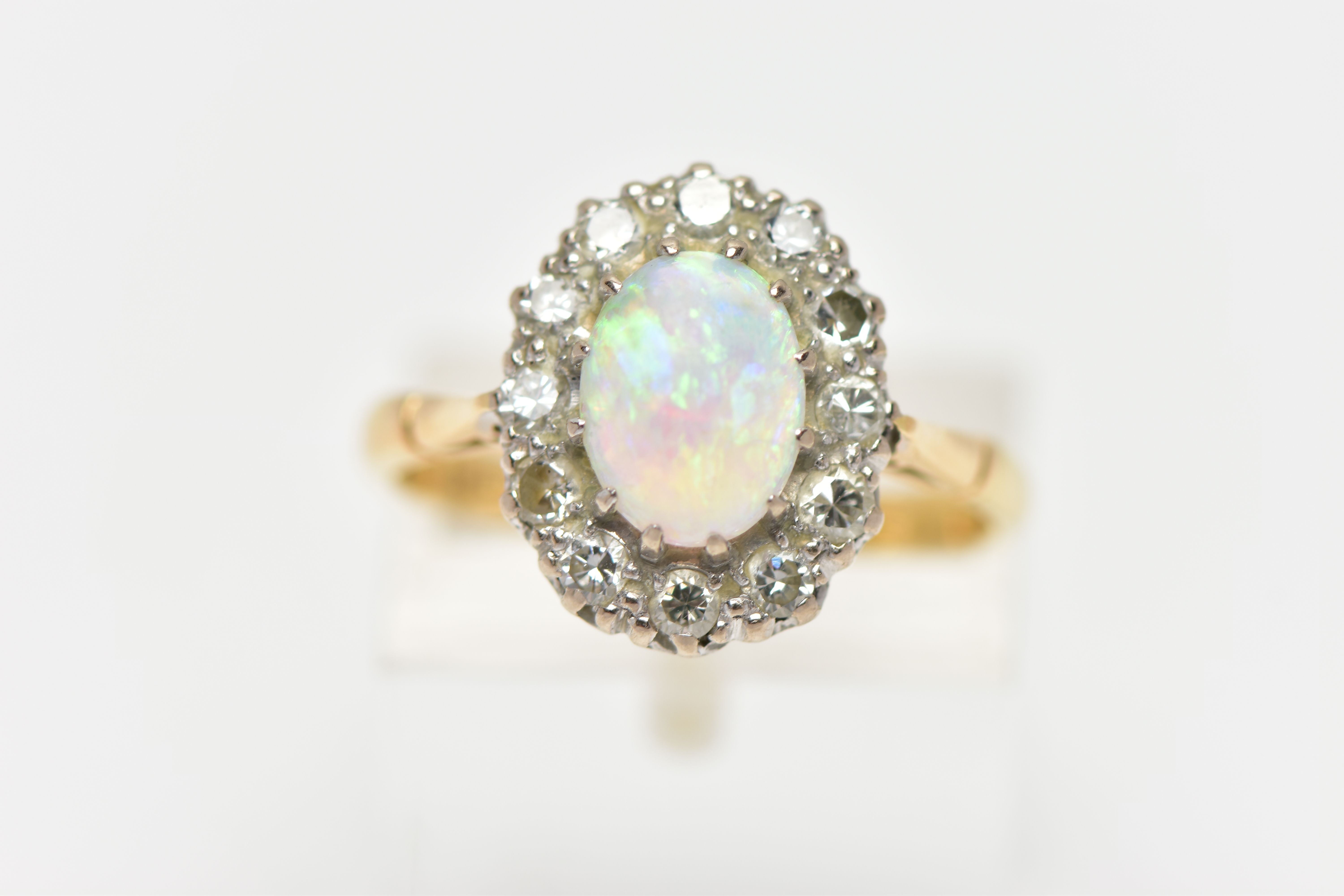 AN OPAL AND DIAMOND CLUSTER RING, set with an oval opal cabochon, measuring approximately 8.2mm x - Image 5 of 10