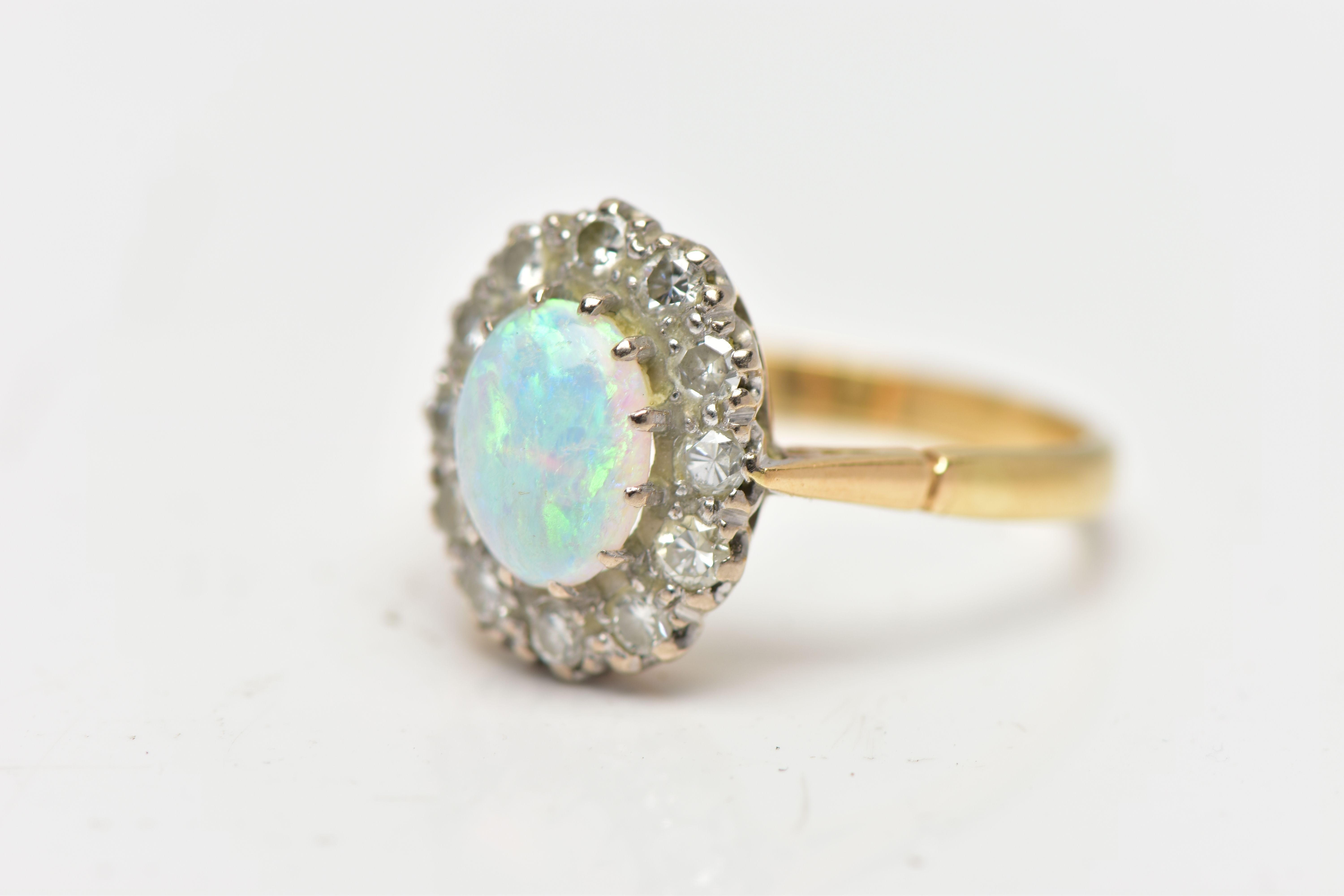 AN OPAL AND DIAMOND CLUSTER RING, set with an oval opal cabochon, measuring approximately 8.2mm x - Image 7 of 10