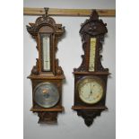 TWO EARLY 20TH CENTURY OAK/MAHOGANY ANEROID BAROMETERS, both with thermometers with one that has a